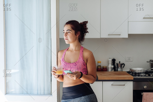 Woman leaning against kitchen door
