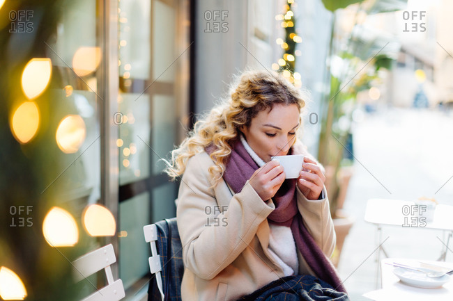 Woman having hot drink at cafe, Firenze, Toscana, Italy