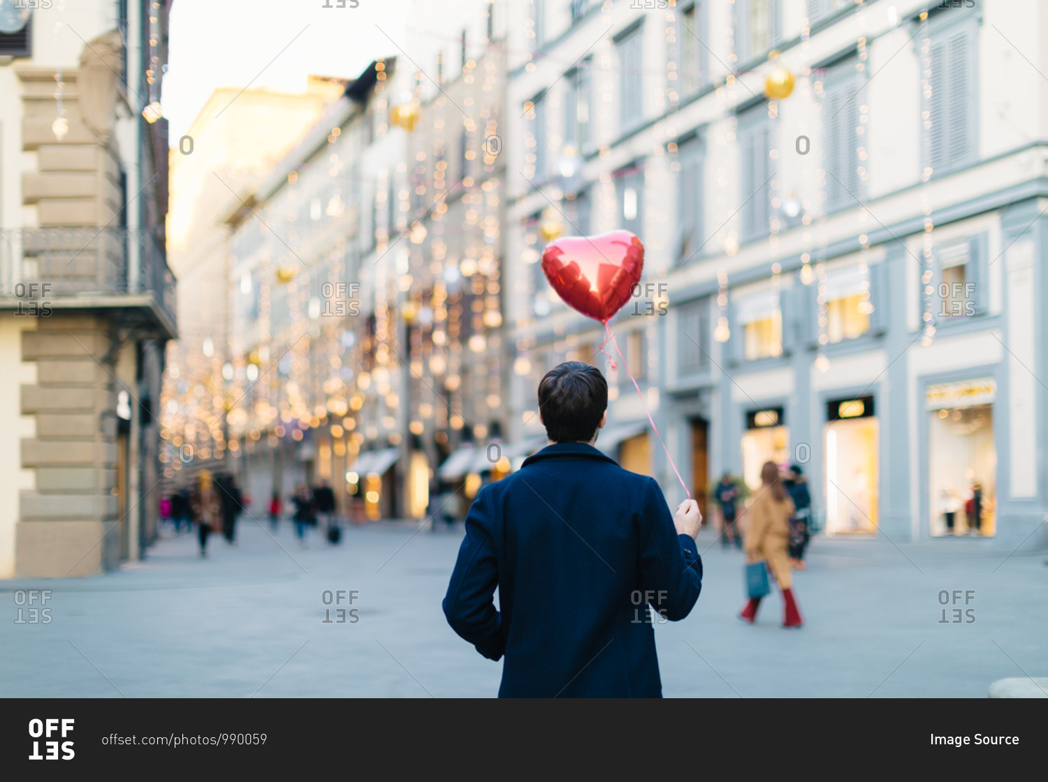 Man with heart shaped balloon at piazza, Firenze, Toscana, Italy