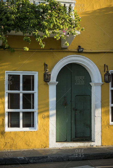 Colorful yellow house wall and green front door in the Old City