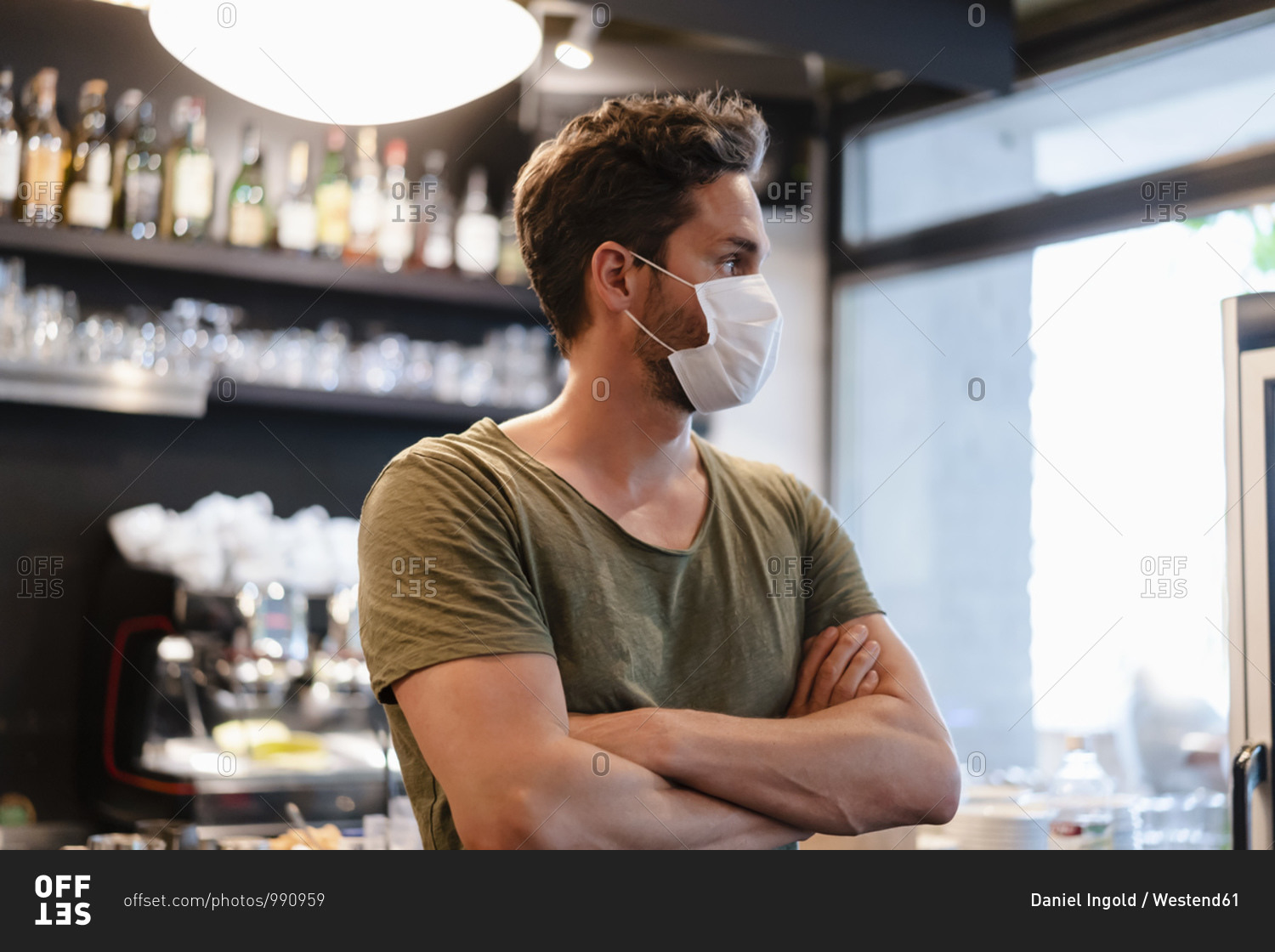 Portrait of restaurant manager with mask looking sideways