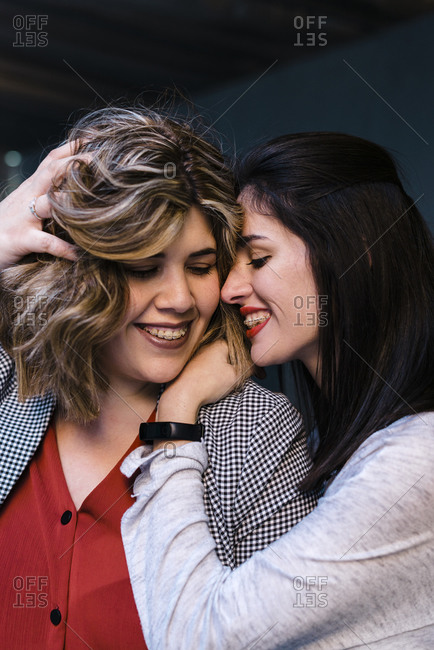 Close-up of happy lesbian couple romancing in city