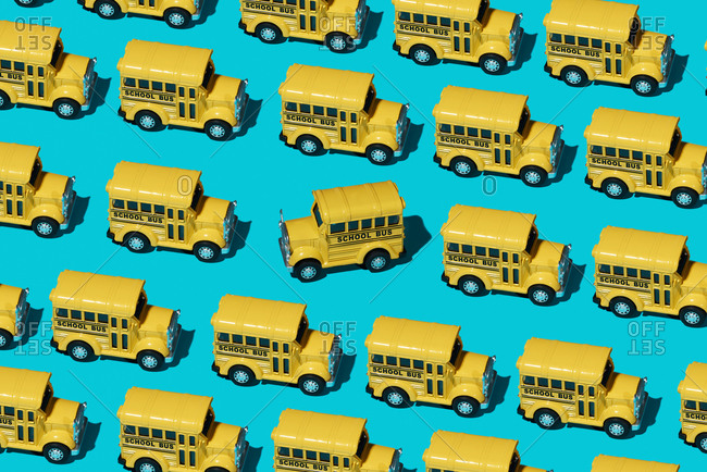 A mosaic of some toy school buses on a blue background