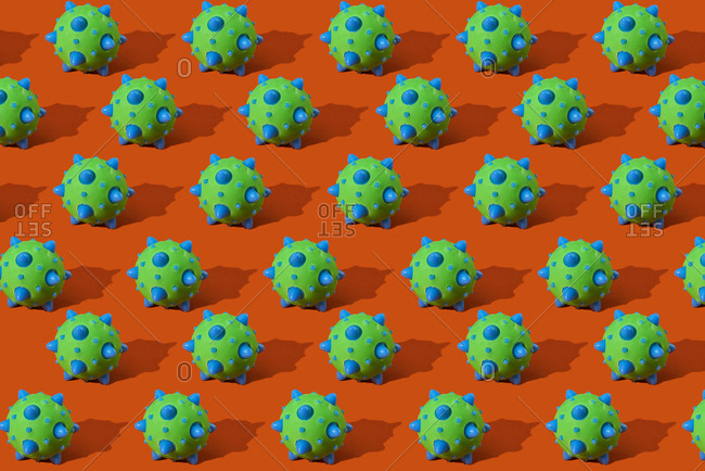 A mosaic of the representation of some SARS-CoV-2 virions, that cause the covid-19, on an orange background