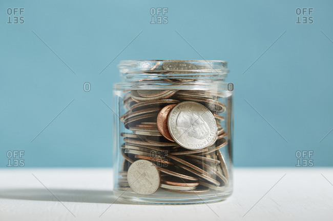 Small jar full of coins savings