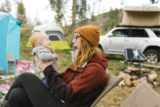 USA, Utah, Uninta Wasatch Cache National Forest, Mother holding son (6-11 months) on campsite