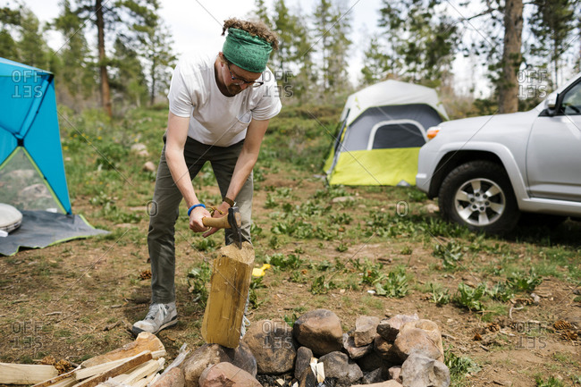 USA, Utah, Uninta Wasatch Cache National Forest, Man chopping wood during camping