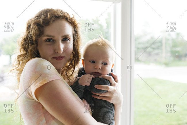 Portrait of woman holding baby son (6-11 months)