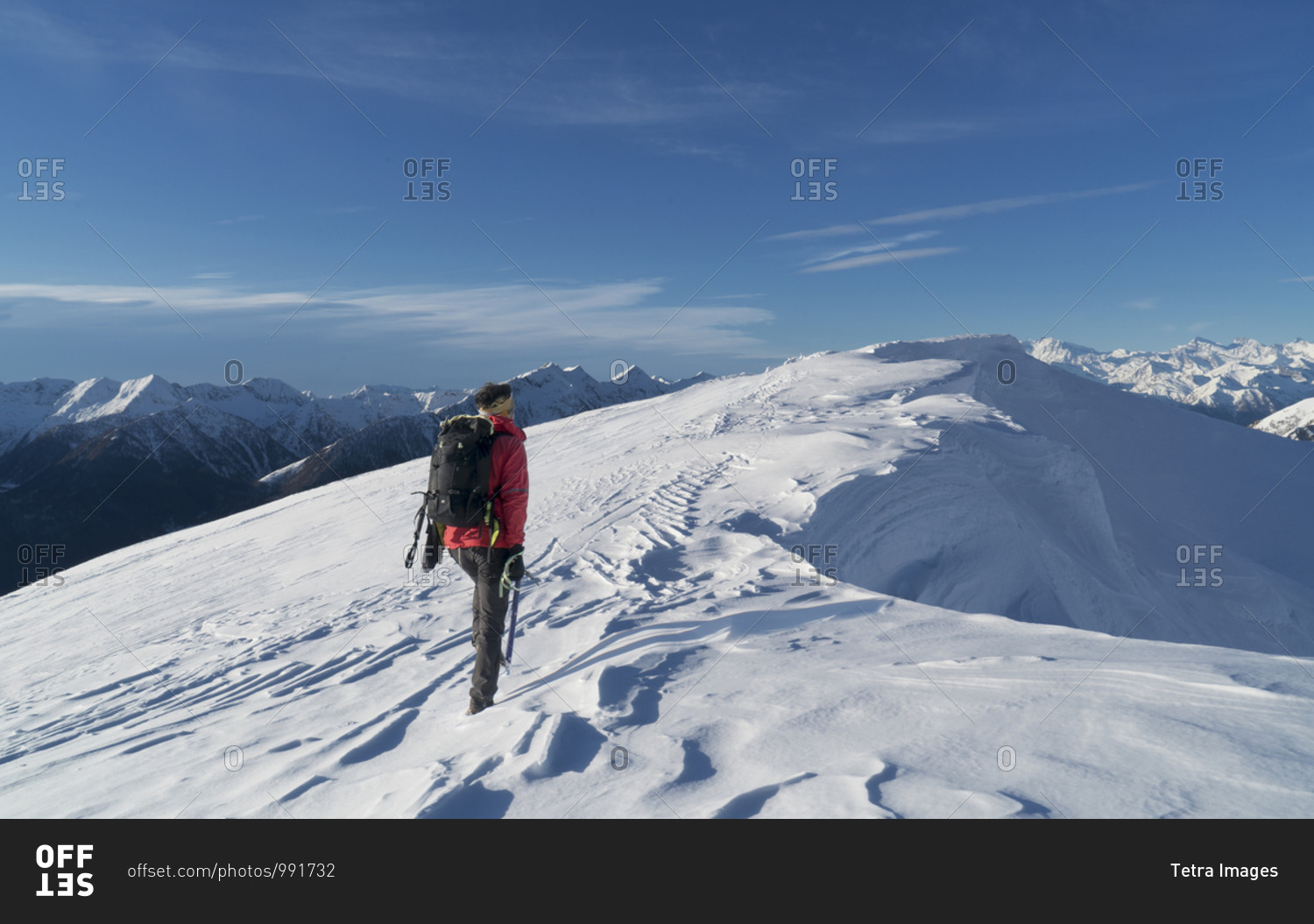 Italy, Piedmont, Alps, Monte Rosa, Climber reaching snow covered mountain top