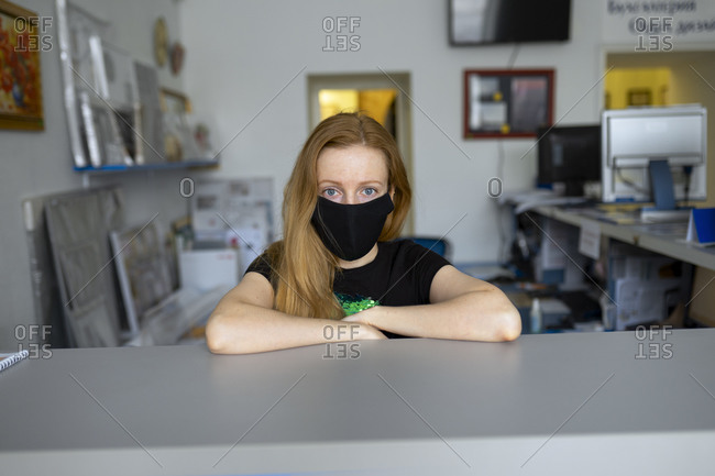 Portrait of woman wearing flu mask in office