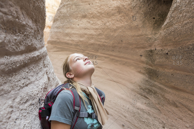 12 year old girl hiking in beautiful slot canyon, Kasha Katuwe, Tent Rocks, NM.