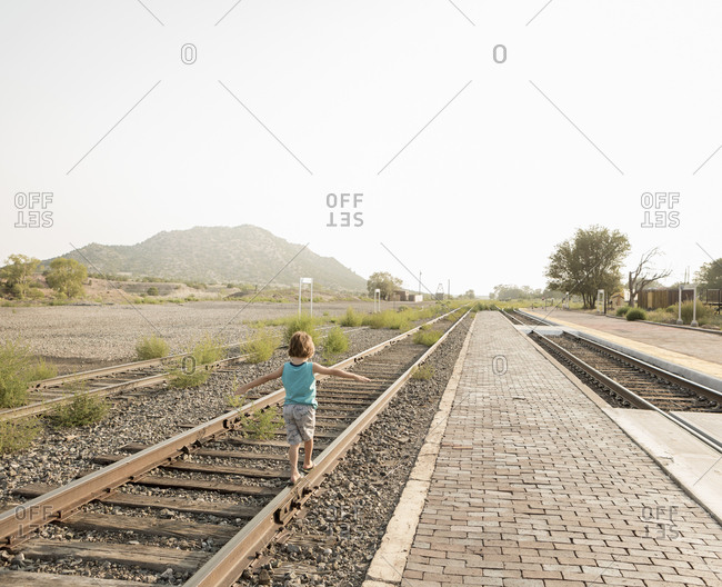 4 year old boy balancing on railroad track, Lamy, NM.