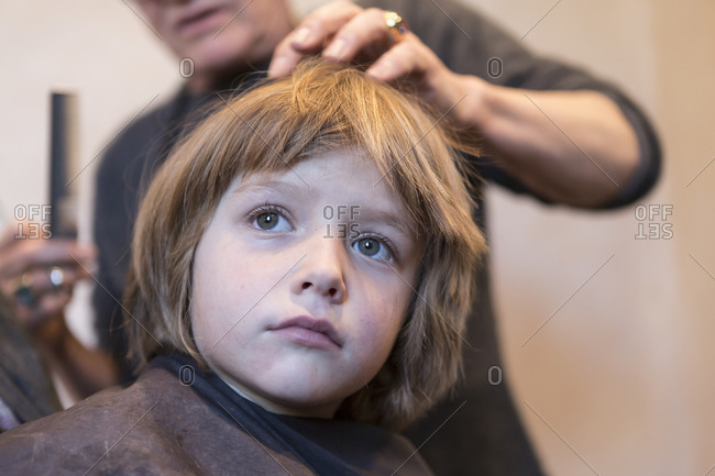 4 year old boy getting a haircut stock photo - OFFSET