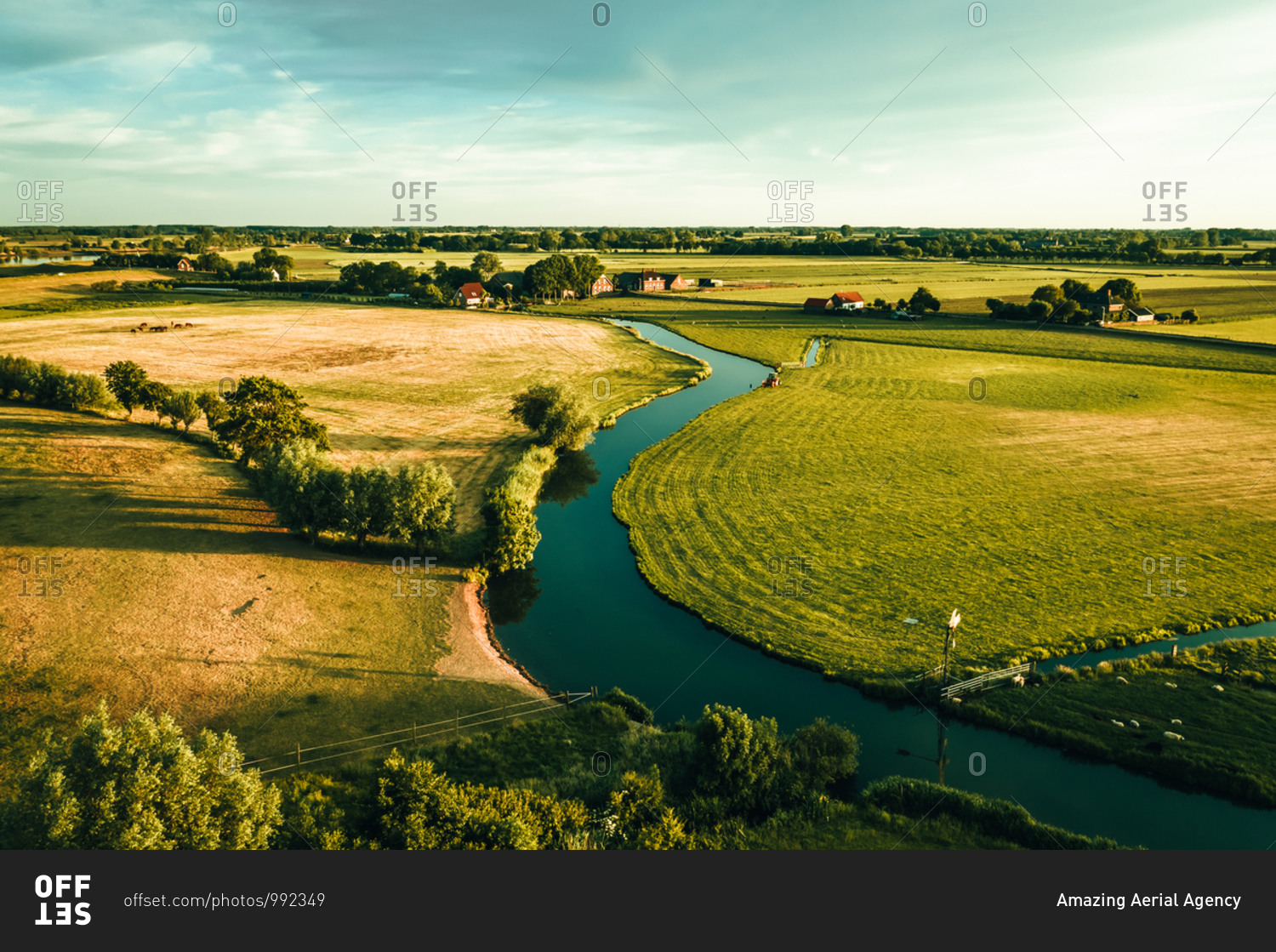 Aerial view of a river running through the idyllic farmlands in IJsselstein, Utrecht, The Netherlands.