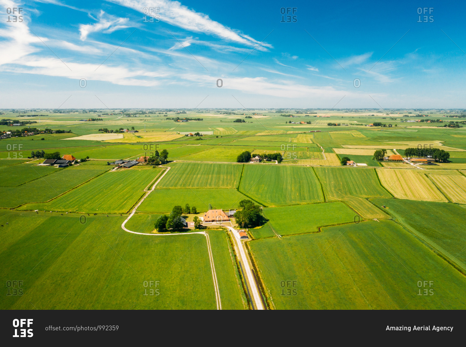Aerial view of farmland with farmer houses in Friesland, The Netherlands.