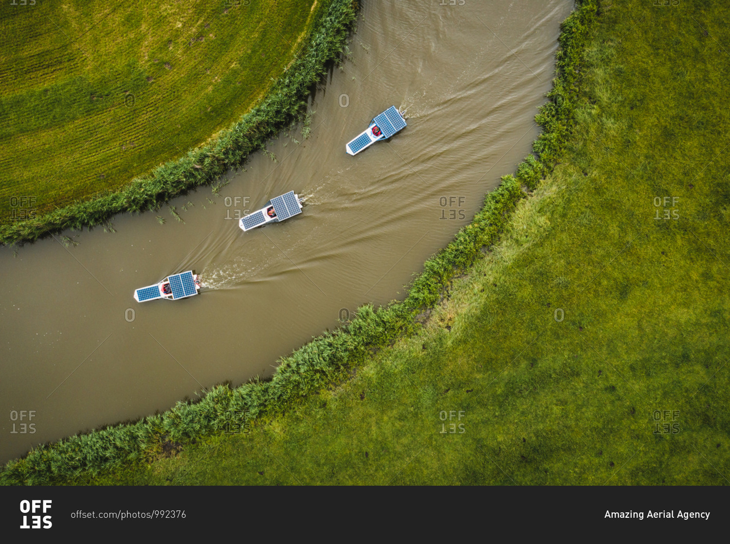 Aerial view of solar panel boats navigating through the farmlands of Schettens, Friesland, The Netherlands.