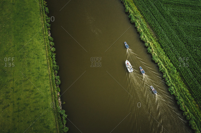Aerial view of solar panel boats navigating through the farmlands in Harlingen, Friesland, The Netherlands.
