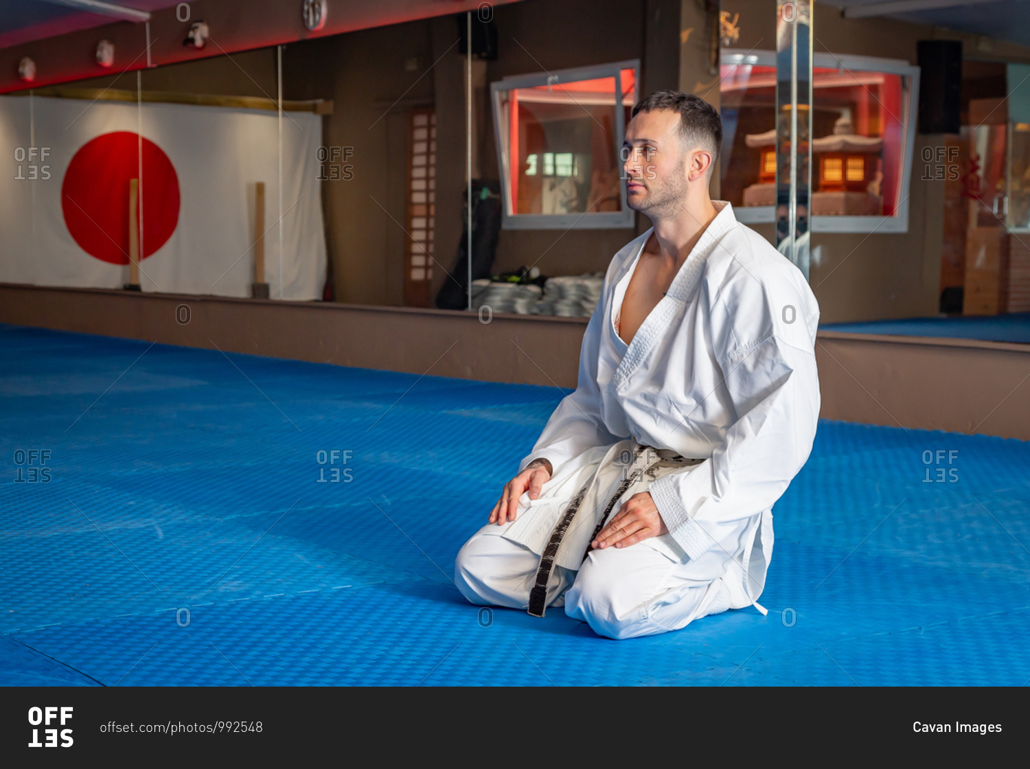 Karate man with traditional Japanese sitting posture on tatami
