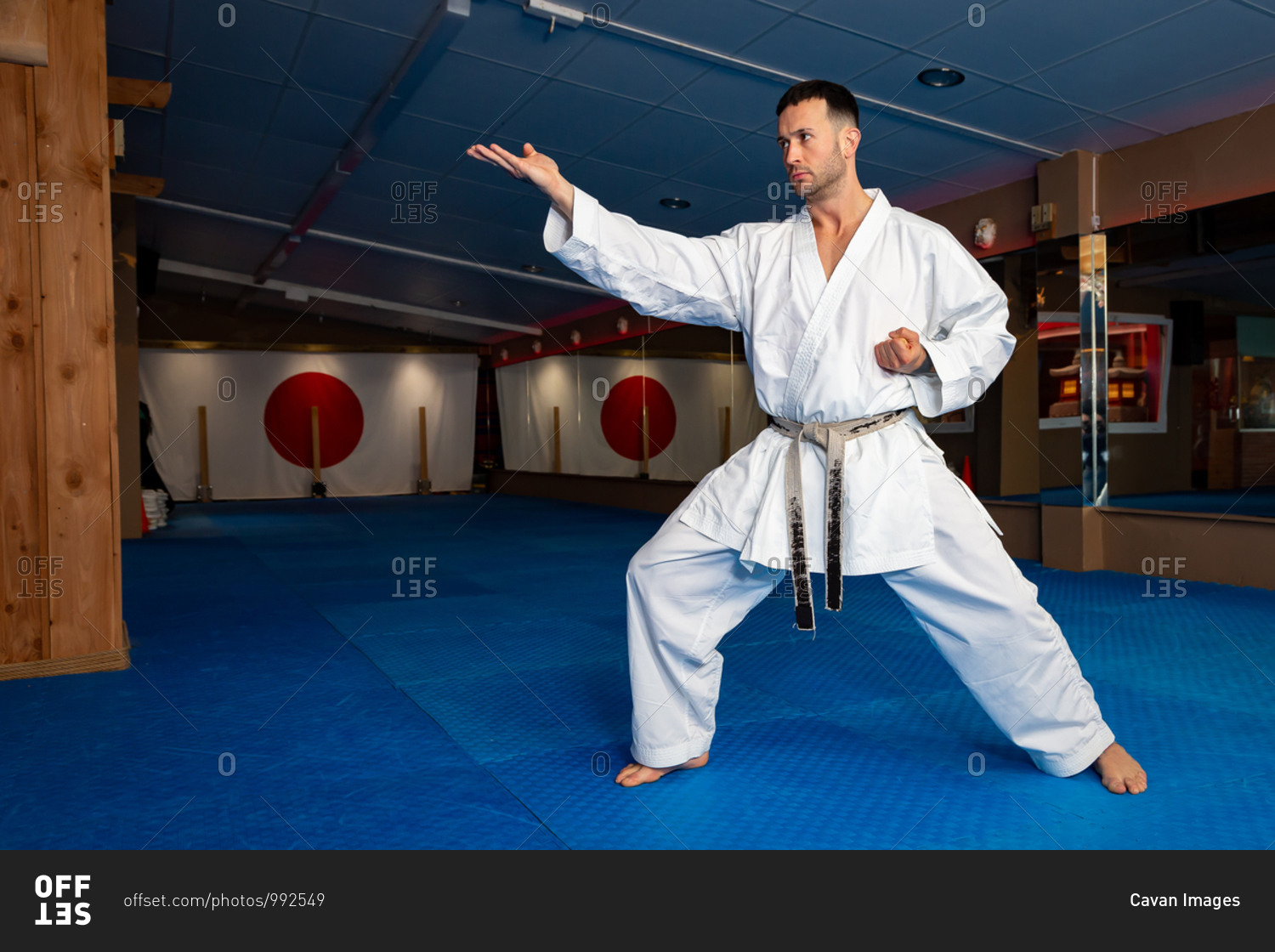 Karate man stand your ground on tatami doing \