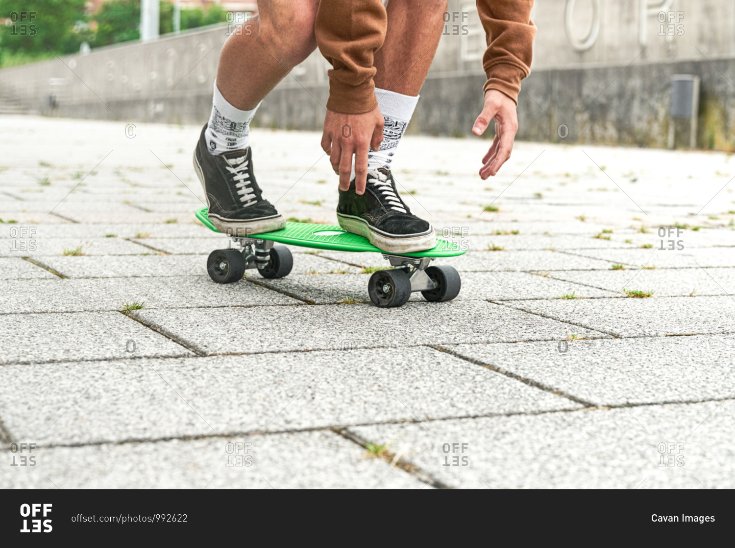 Close-up of Skateboarder doing a trick at the park. Concept of leisure activity, sport, extreme, hobby and motion.