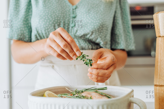 Female hands holding thyme for seasoning food