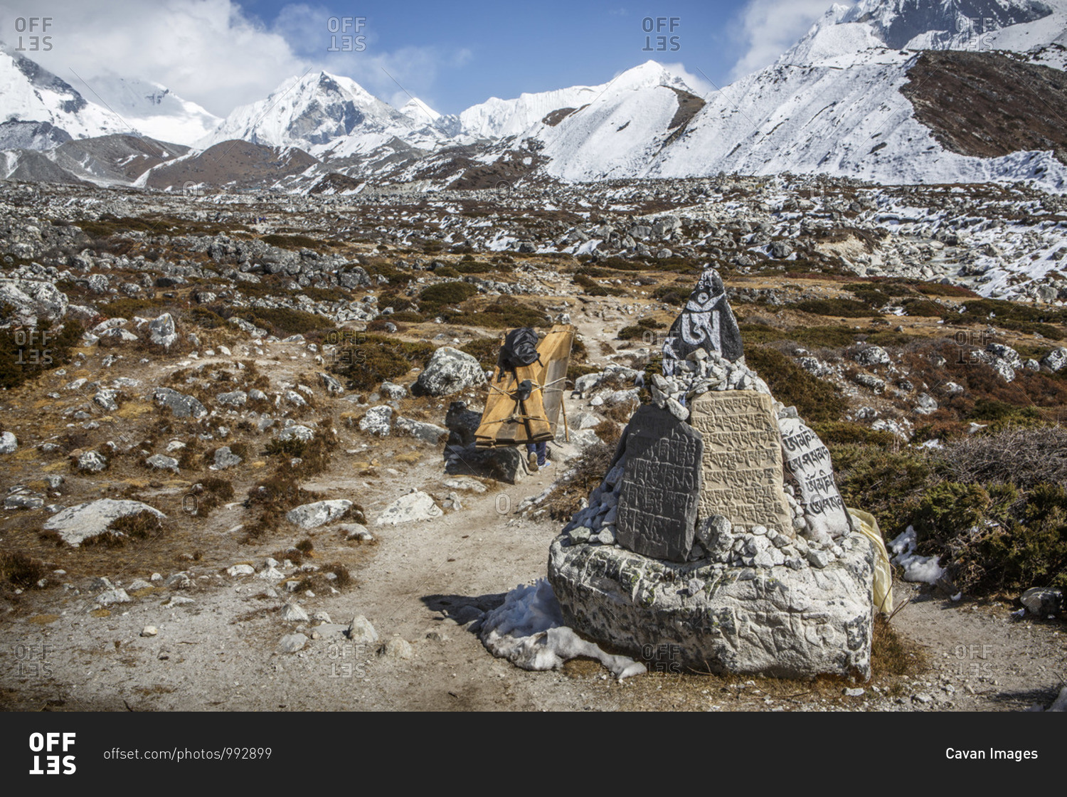 A porter carries goods past prayer stones in Nepal's Khumbu Valley.