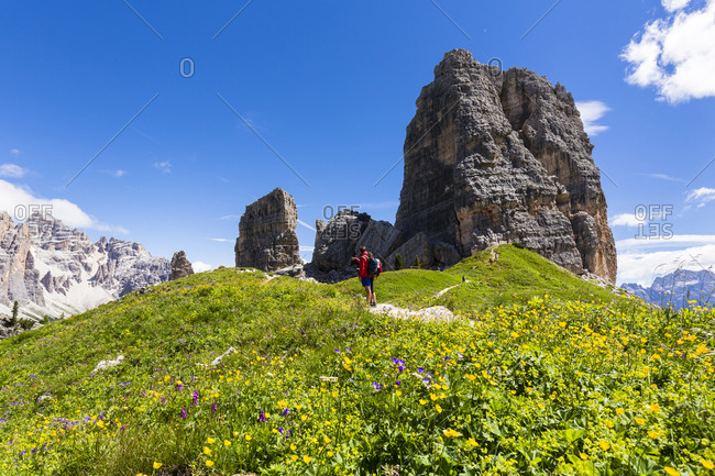 Mountain hiker in front of Cinque Torri (2361m), Dolomites, Alps, Province of Belluno, Veneto, Italy