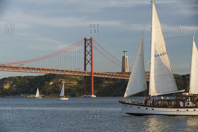 October 2, 2019: Sailing ship, Ponte 25 de Abril, Tajo River, Lisbon, Portugal