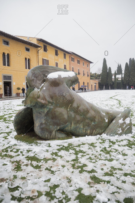 March 1, 2018: A fallen angel sculpture under a snowy weather, Pisa, Central Italy, Europe