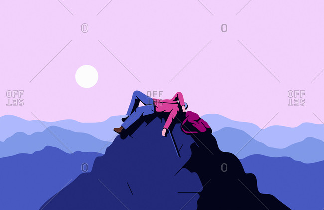 Exhausted mountaineer lying on mountain summit