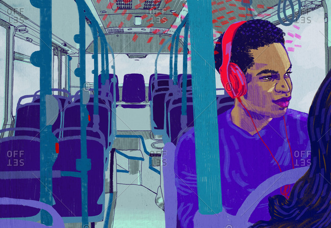 Man on bus listening to headphones