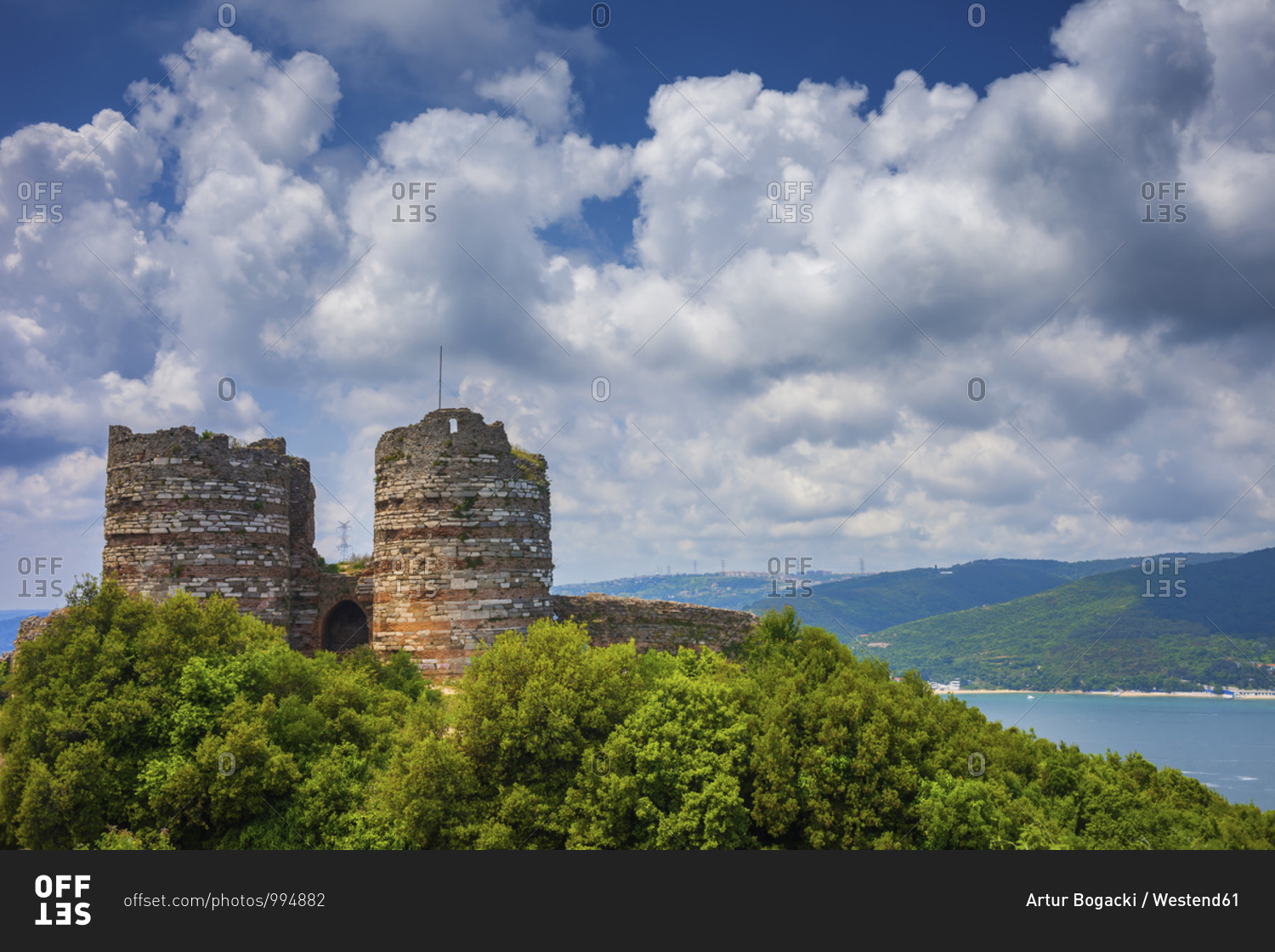 Turkey- Istanbul- Large white clouds over ruins of Yoros Castle