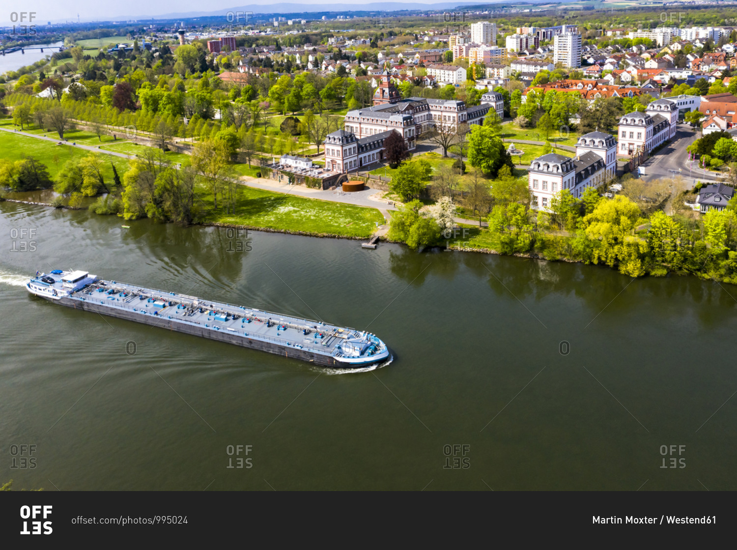 Germany- Hesse- Hanau- Helicopter view of barge passing riverside town in summer