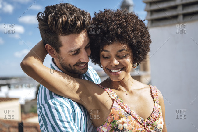 Romantic mid adult couple smiling during sunny day