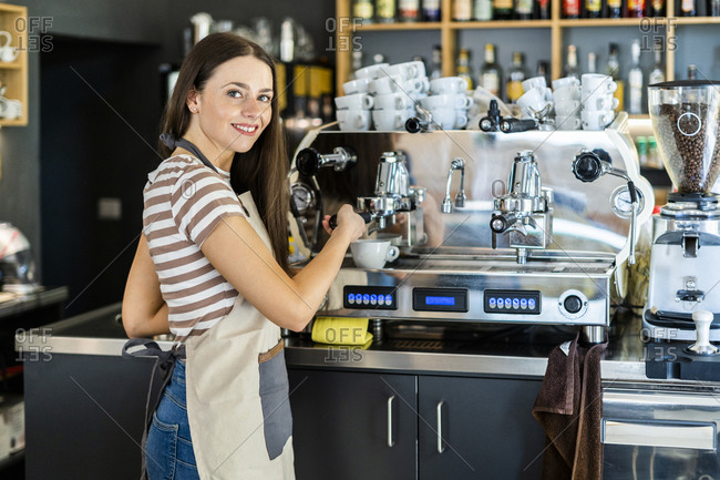 barista holding tamper near portafilter with grinded coffee, espresso, manual  press Stock Photo by LightFieldStudios