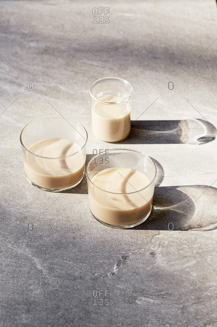 Three glass containers filled with milk alternatives