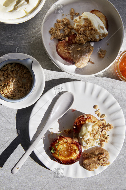 Roasted and grilled nectarines with thyme, honey, yoghurt, nut butter and granola with dramatic shadows