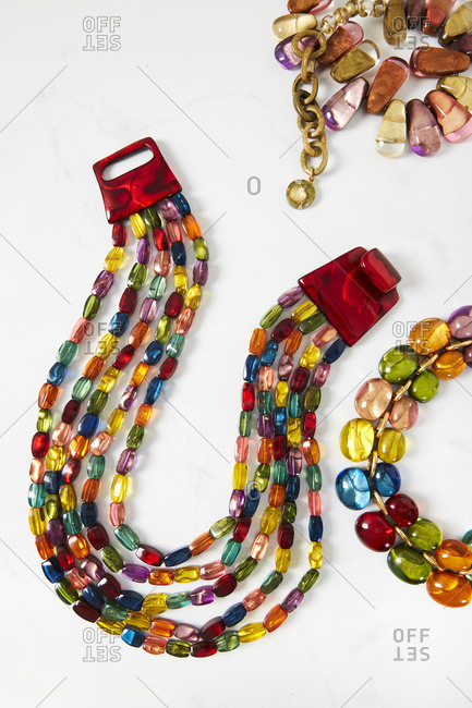 Multicolored beaded necklaces with on light background