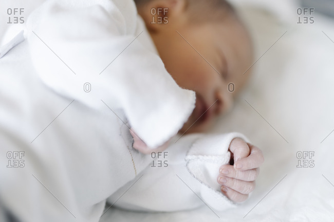 Newborn baby boy sleeping on a blanket stock photo - OFFSET