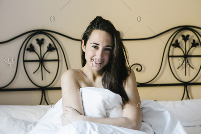 Portrait of a laughing happy woman in bed