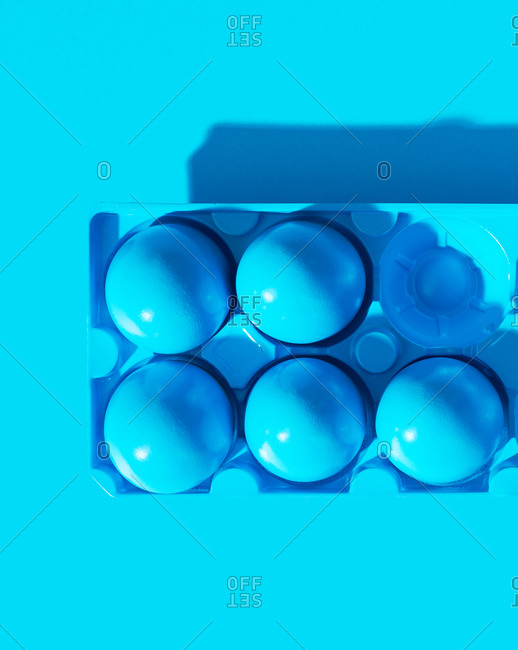 Blue painted eggs on blue background