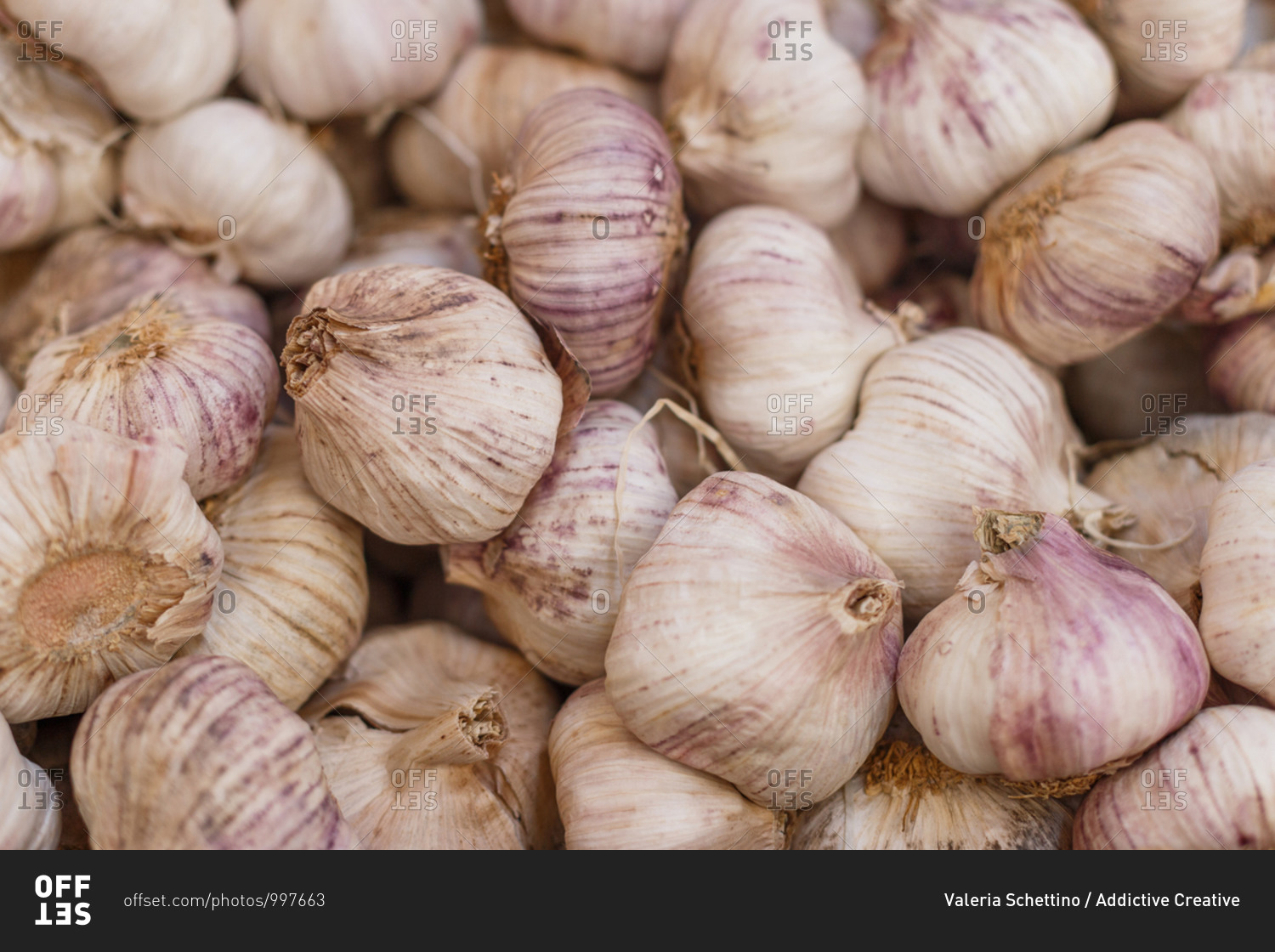High angle of heap of raw garlic in grocery market