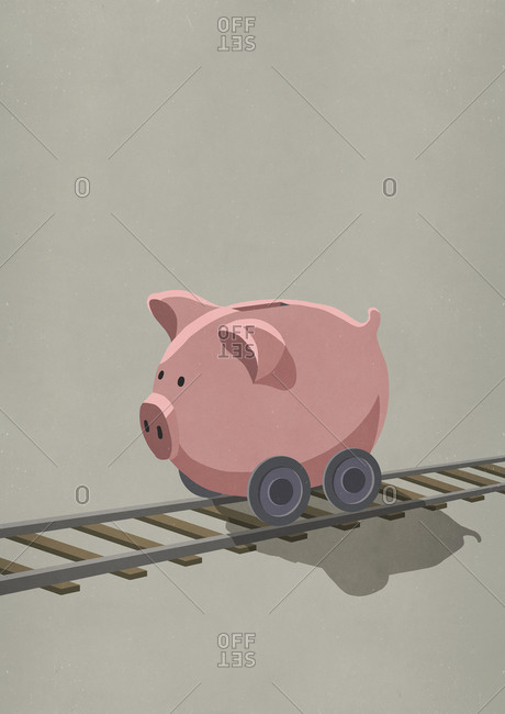 Piggy bank on wheels rolling on train tracks