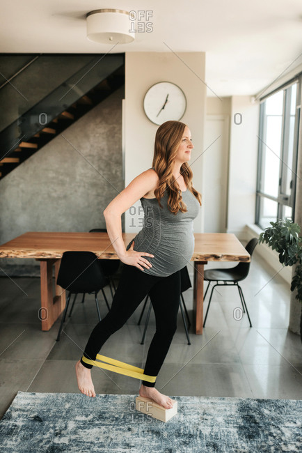 Pregnant woman doing balancing and strengthening exercise