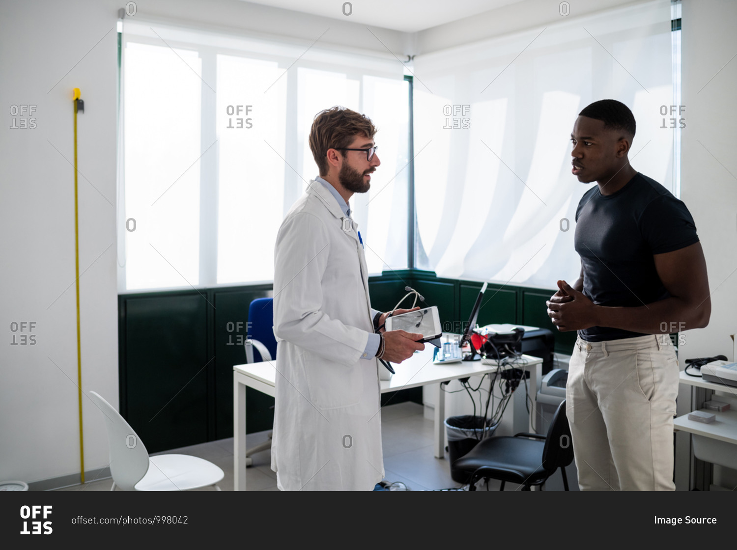 Doctor speaking with patient in consultation room