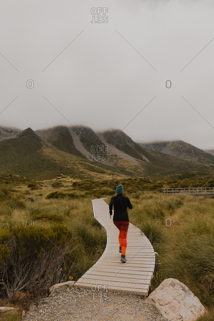 Woman jogging on trail path, Wanaka, Taranaki, New Zealand