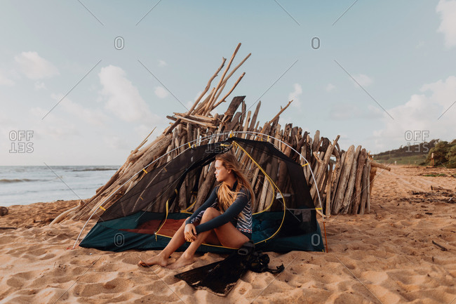 Scuba diver camping on sandy beach, Princeville, Hawaii, US