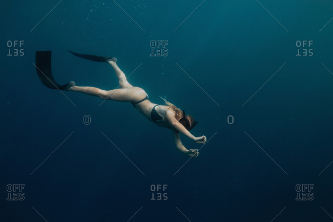 Woman swimming underwater - Offset Collection