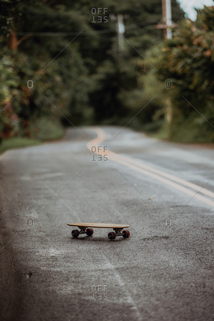 Skateboard on rural road, selective focus, Haiku, Hawaii, USA