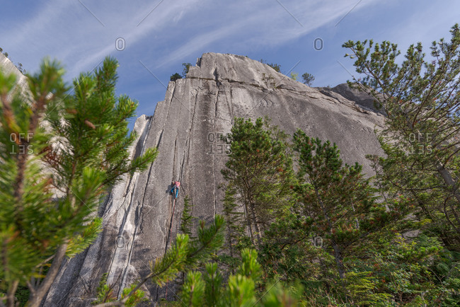 Rock climber scaling Heatwave, on top of The Chief, Squamish, Canada